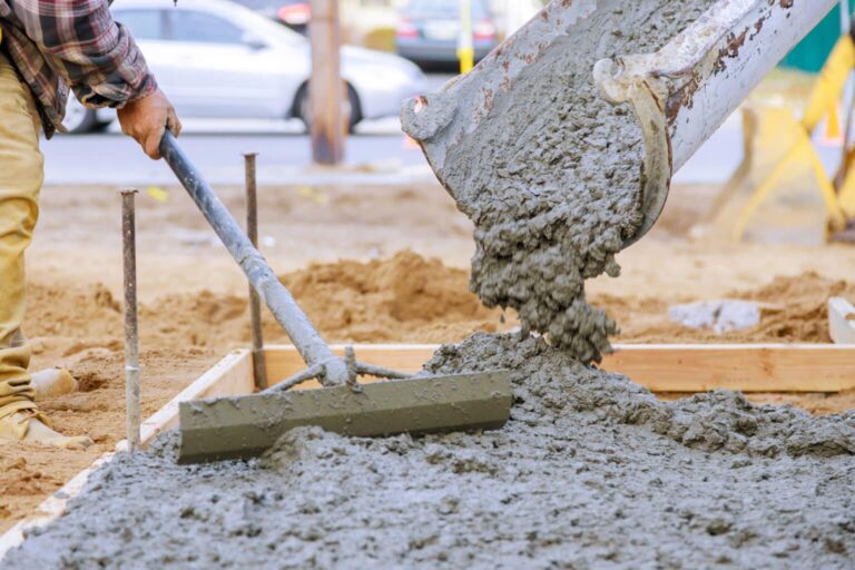 Newly poured on laying concrete cement with sidewalk